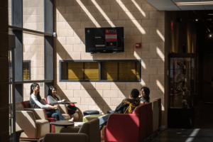 four students sitting in the lounge area