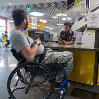 man in a wheelchair at the cafe counter