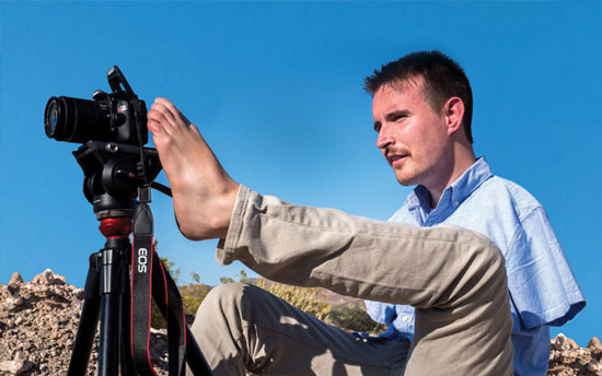 Student takes photographs using his feet