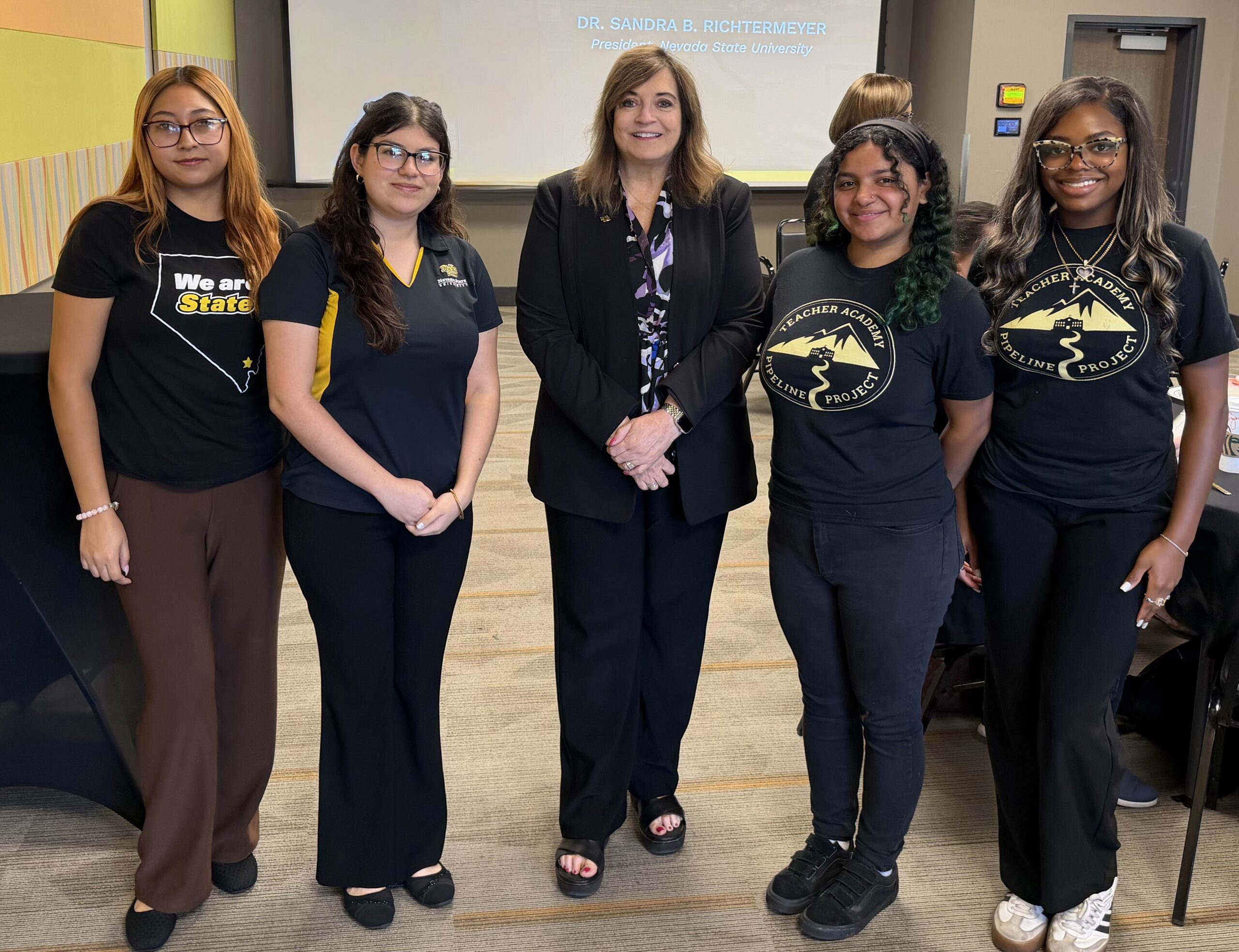 Nevada State University President Dr. Sandra B. Richtermeyer stands with four student volunteers at the second annual Education Summit. Nevada State University President Dr. Sandra B. Richtermeyer stands with four student volunteers at the second annual Education Summit.