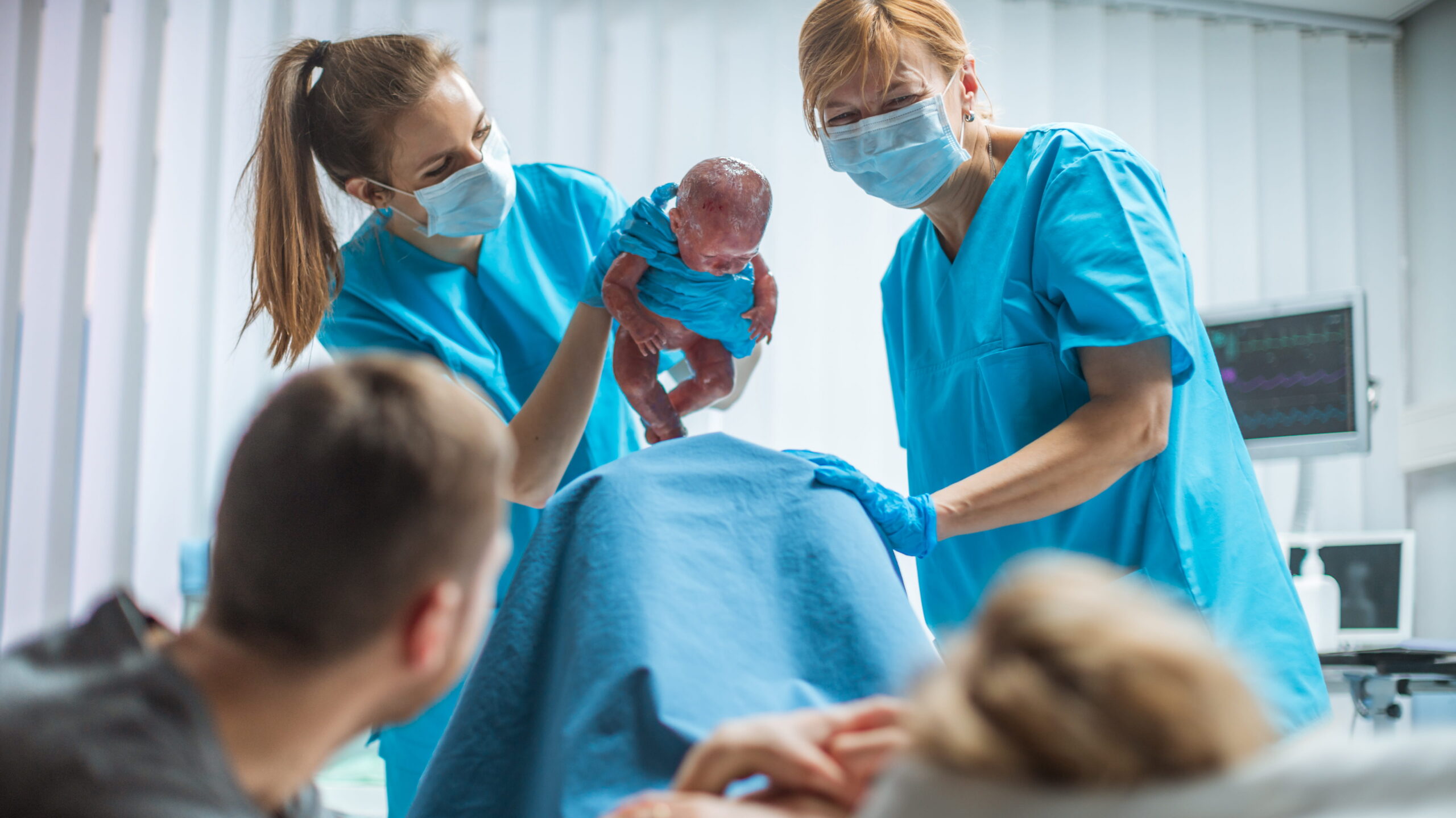 labor-delivery-min1 (1) Labor and delivery nurses care for a newborn immediately after birth while assisting the mother.